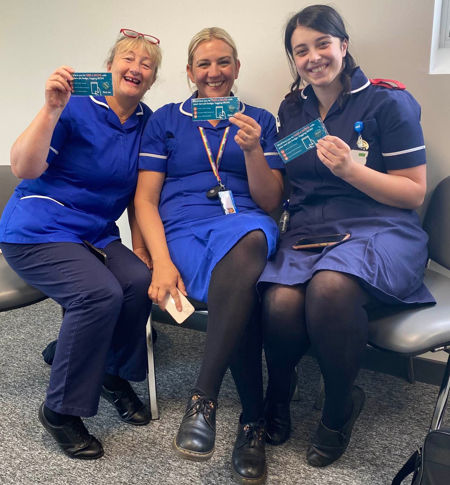 Happy smiling NHS Staff with IKON Trained pin badges